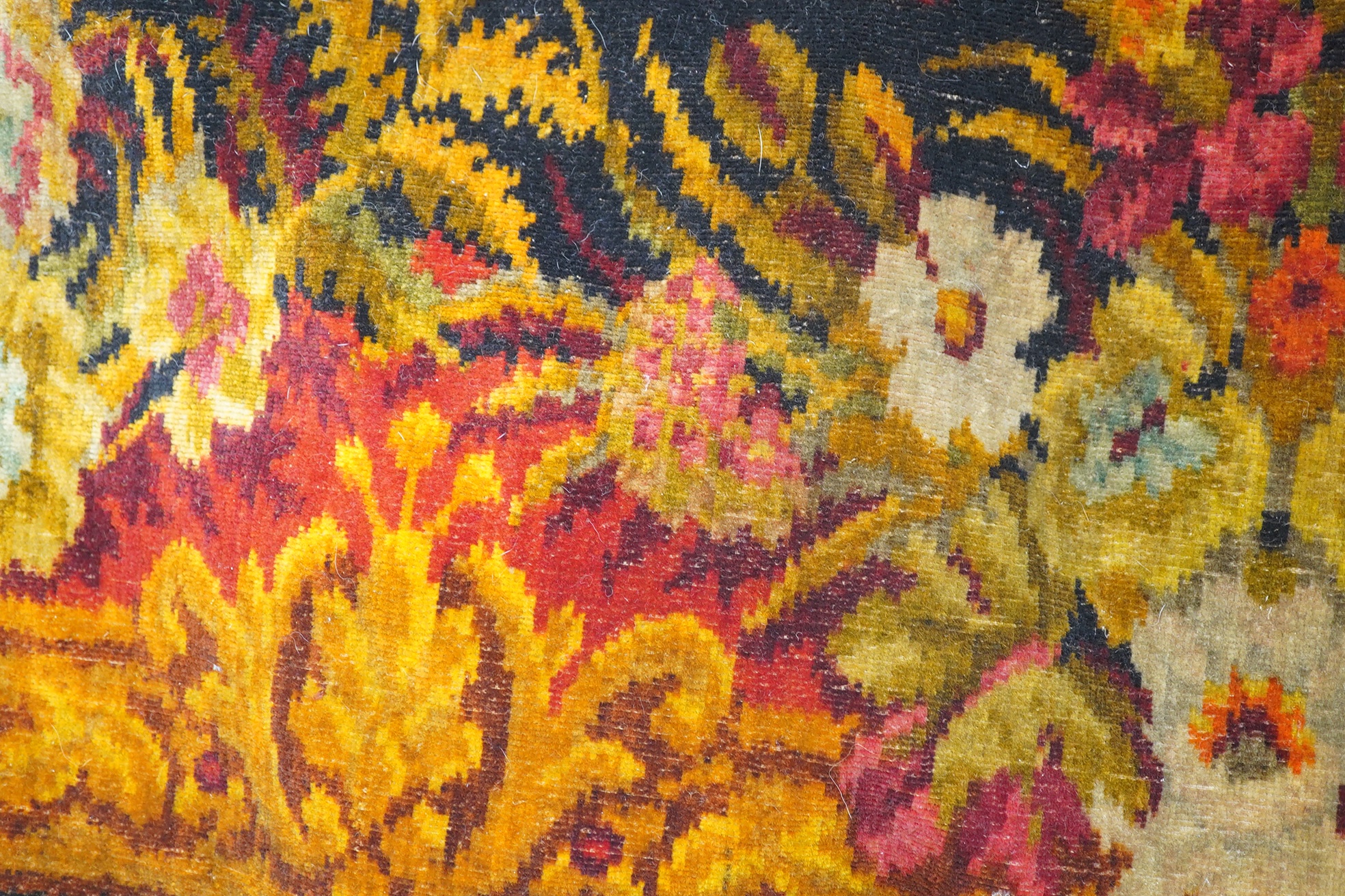 An Edwardian table cover in brightly coloured wools, with a floral design, together with a later 20th century continental grey, beige and cream patterned silk cover, Edwardian table cover 220cm x 172cm. Condition - colou